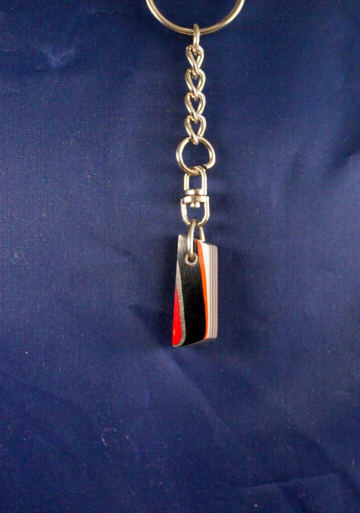 Keychain with striped rectangular pendant.