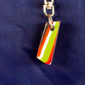 Colorful striped keychain on blue background.