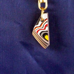 Colorful layered keychain on blue background.