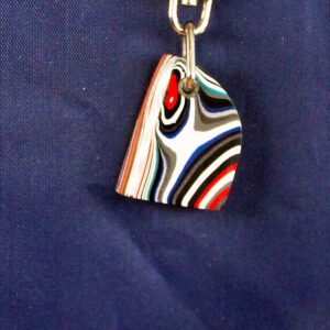 Colorful striped keychain against blue background.