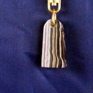 Striped stone pendant on gold keychain.