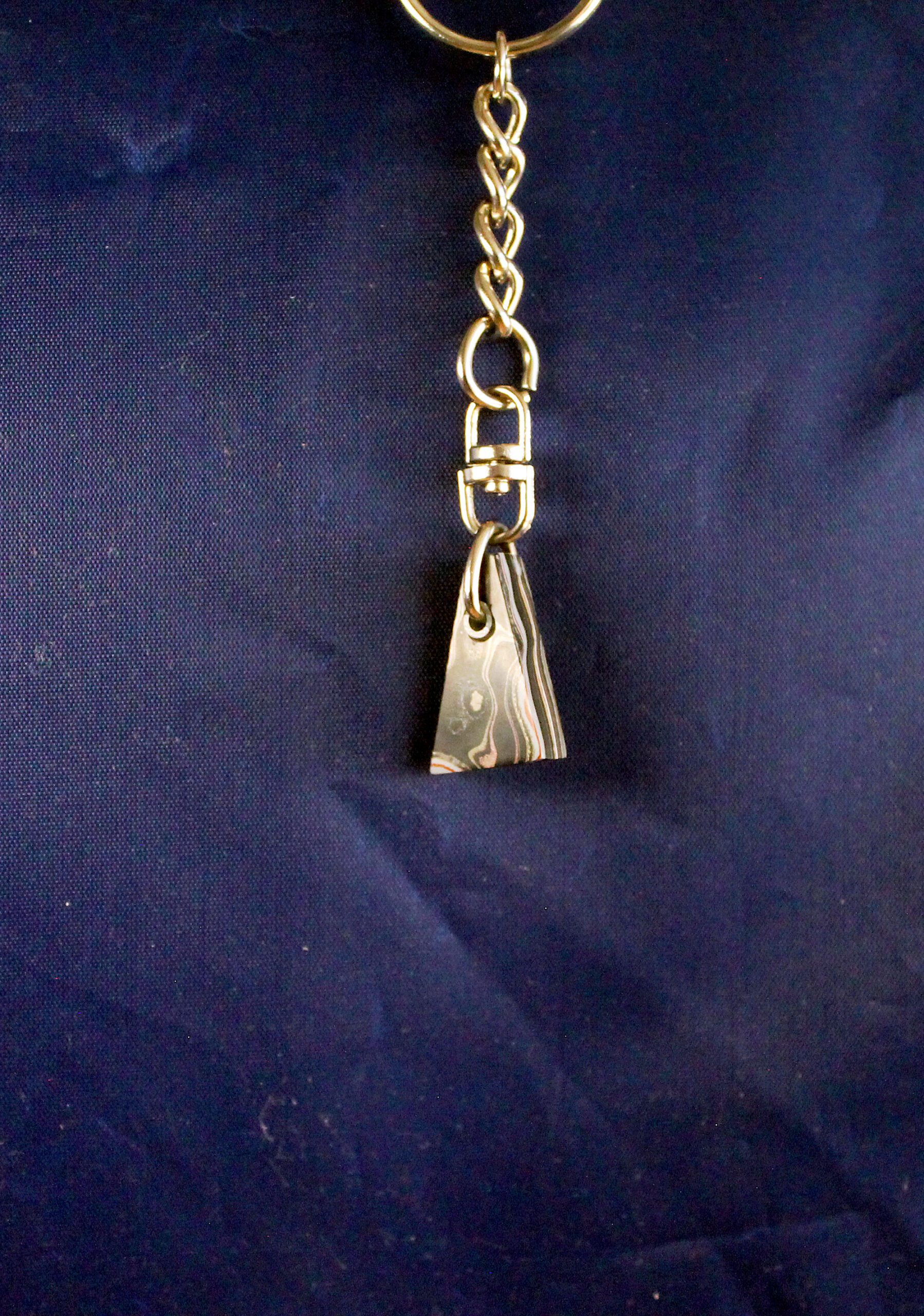 Metal keychain with triangular pendant.