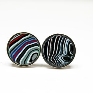 Colorful striped round cufflinks on white background.
