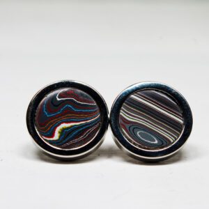 Colorful striped circular cufflinks on display.