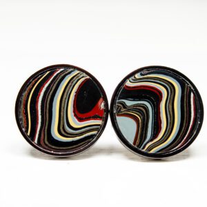 Round colorful cufflinks with swirling patterns.