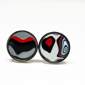 Colorful abstract design round earrings on display.