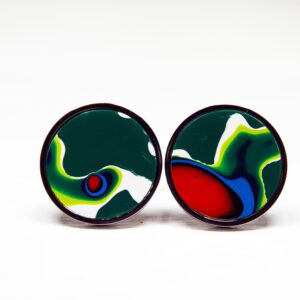 Colorful abstract circular earrings on white background.