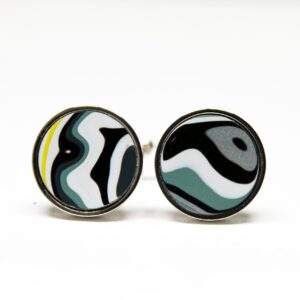 Round cufflinks with abstract black and white design.