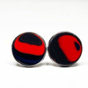 Red and black round cufflinks on white.