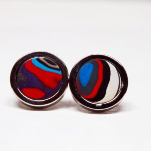 Colorful round earrings on white background.
