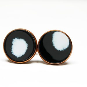 Black and white round cufflinks on display.