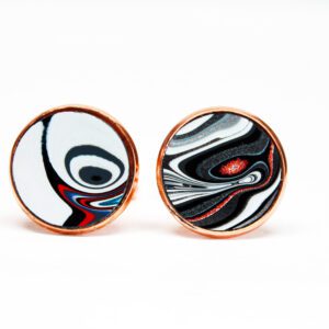 Circular earrings with abstract black and red design.