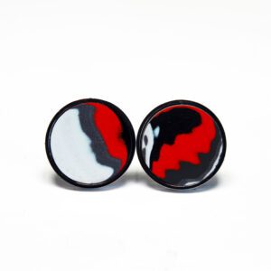 Red, white, black patterned round earrings.
