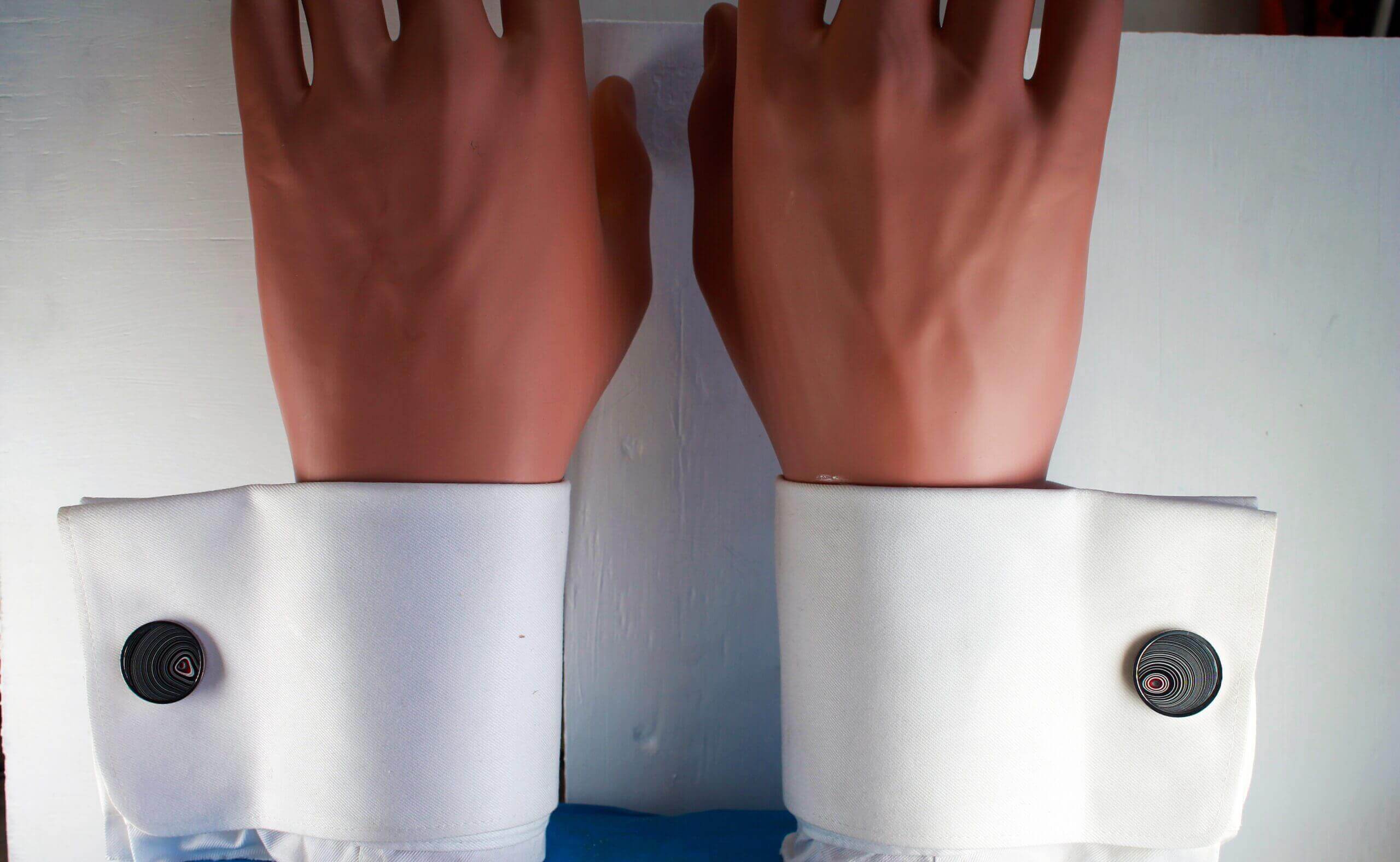 Hands with white cuffs and buttons.