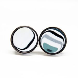 Round earrings with black and white patterns.