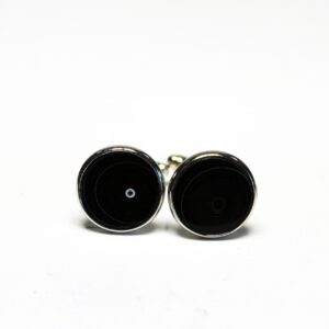 Black round cufflinks on white background.