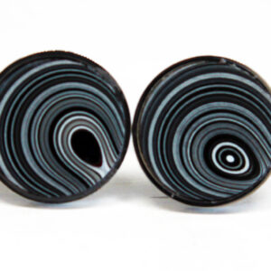 Two round objects with concentric black patterns.