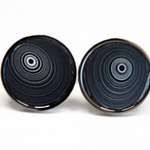 Black circular cufflinks with concentric patterns.