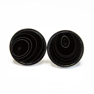 Black circular earrings with concentric patterns.