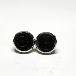 Black circular cufflinks on white background.