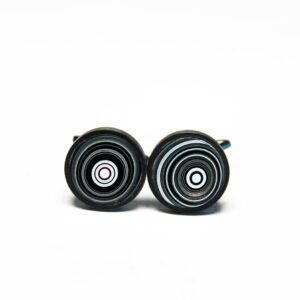 Black circular cufflinks with concentric designs.
