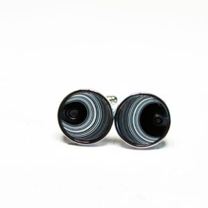 Black and white swirl cufflinks on display.