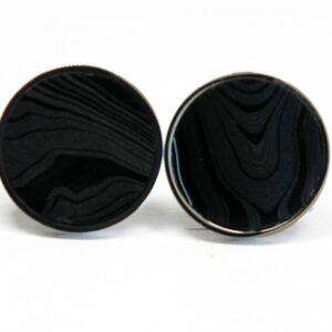 Black round cufflinks with textured pattern.
