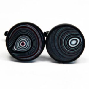 Round cufflinks with concentric circle patterns.