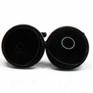 Two black circular objects on white background.