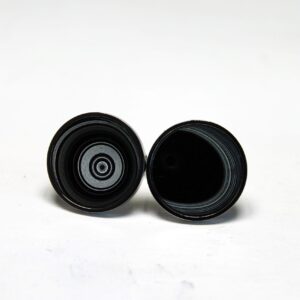 Two black cylindrical objects on white background.