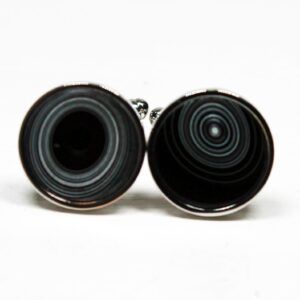 Black circular cufflinks with concentric patterns.