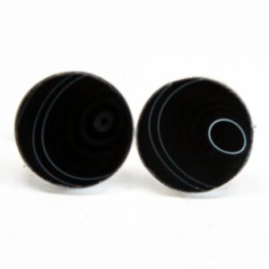 Black circular objects with white line patterns.