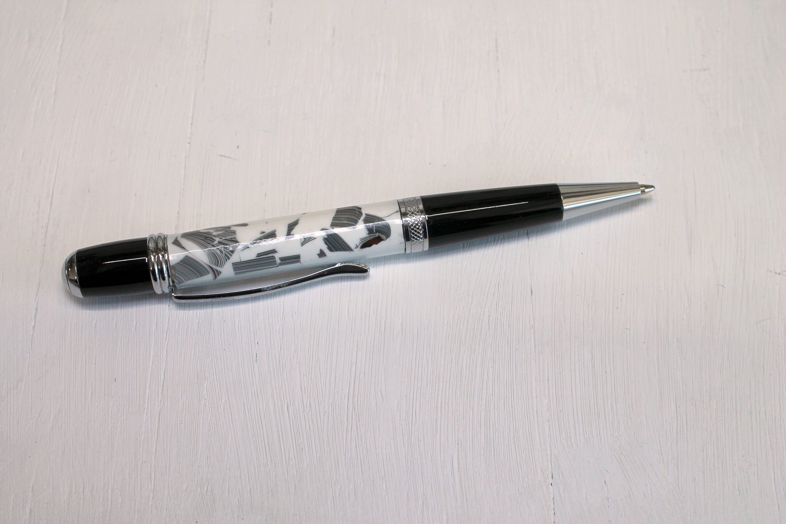 Black and silver pen on white background.
