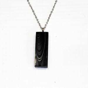 Black pendant necklace on a chain.
