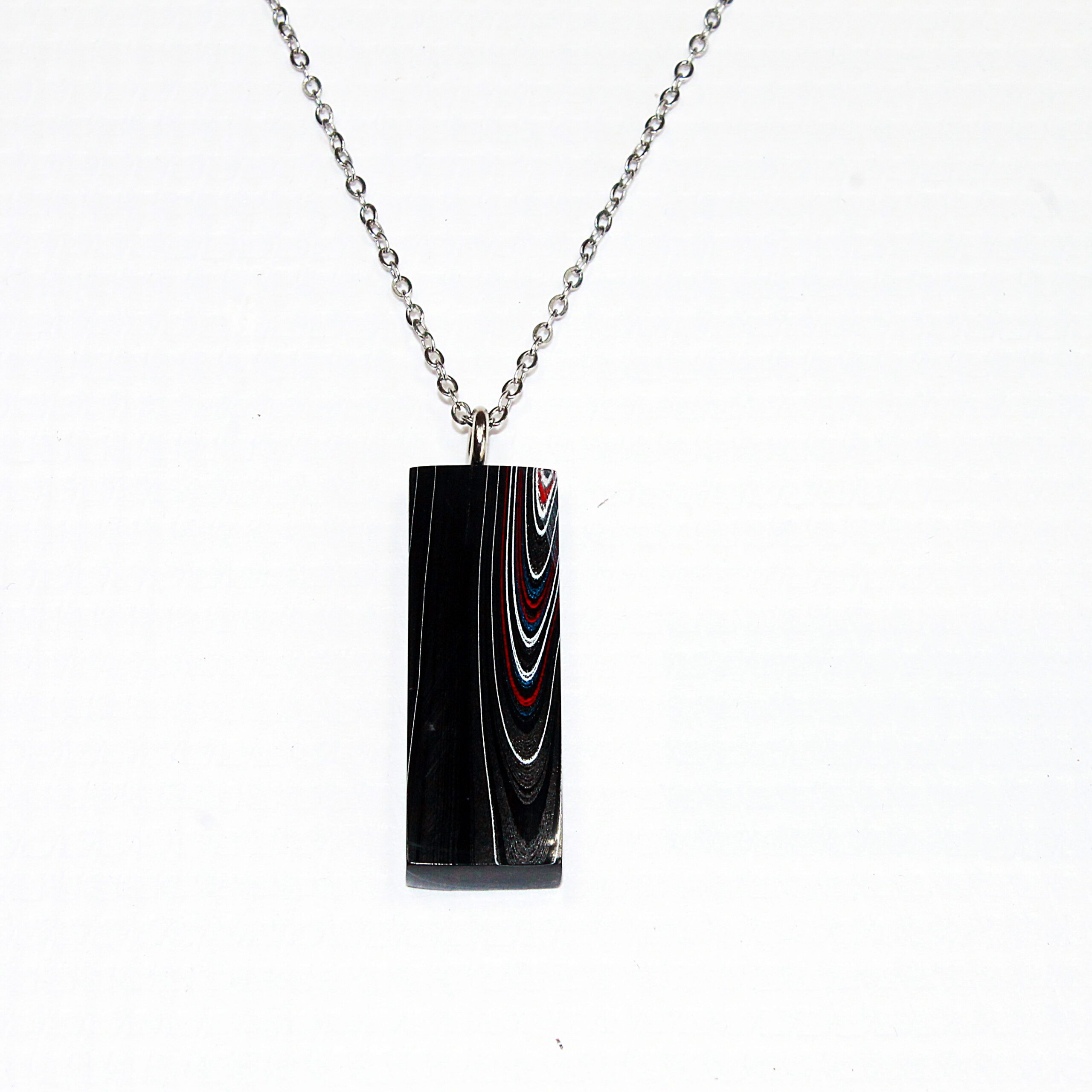 Necklace with patterned rectangular pendant.