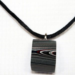 Striped pendant necklace on black cord.