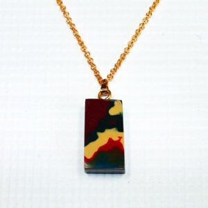 Multicolored pendant on a gold chain.