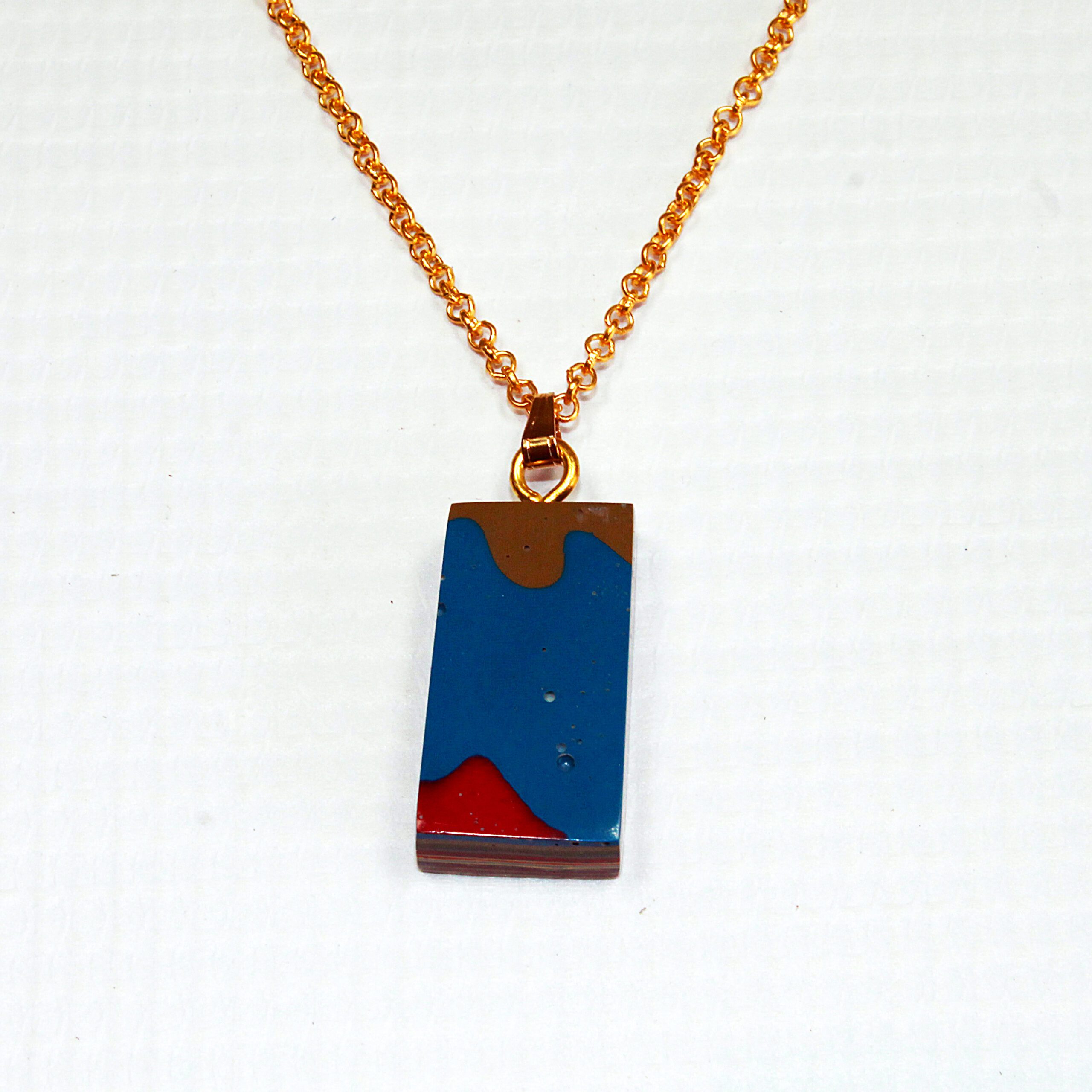 Colorful pendant necklace with gold chain.
