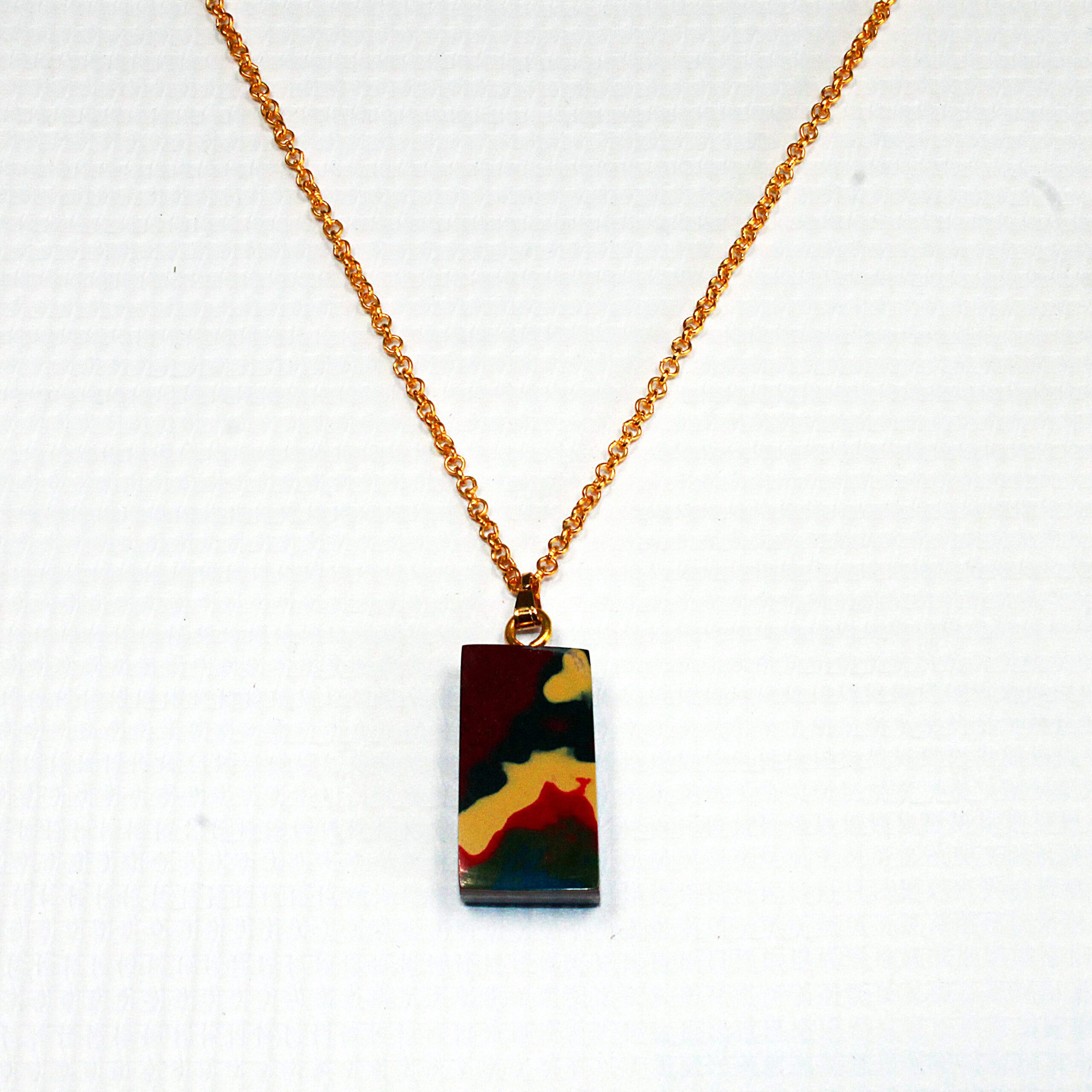 Colorful pendant on a gold chain necklace.