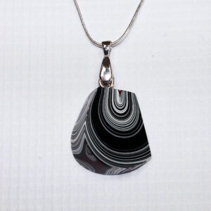 Black and white striped pendant necklace.