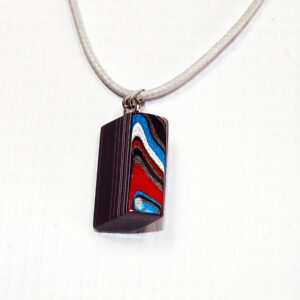 Colorful abstract pendant on a white background.