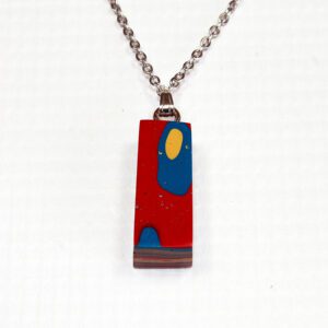 Colorful abstract pendant on silver chain.