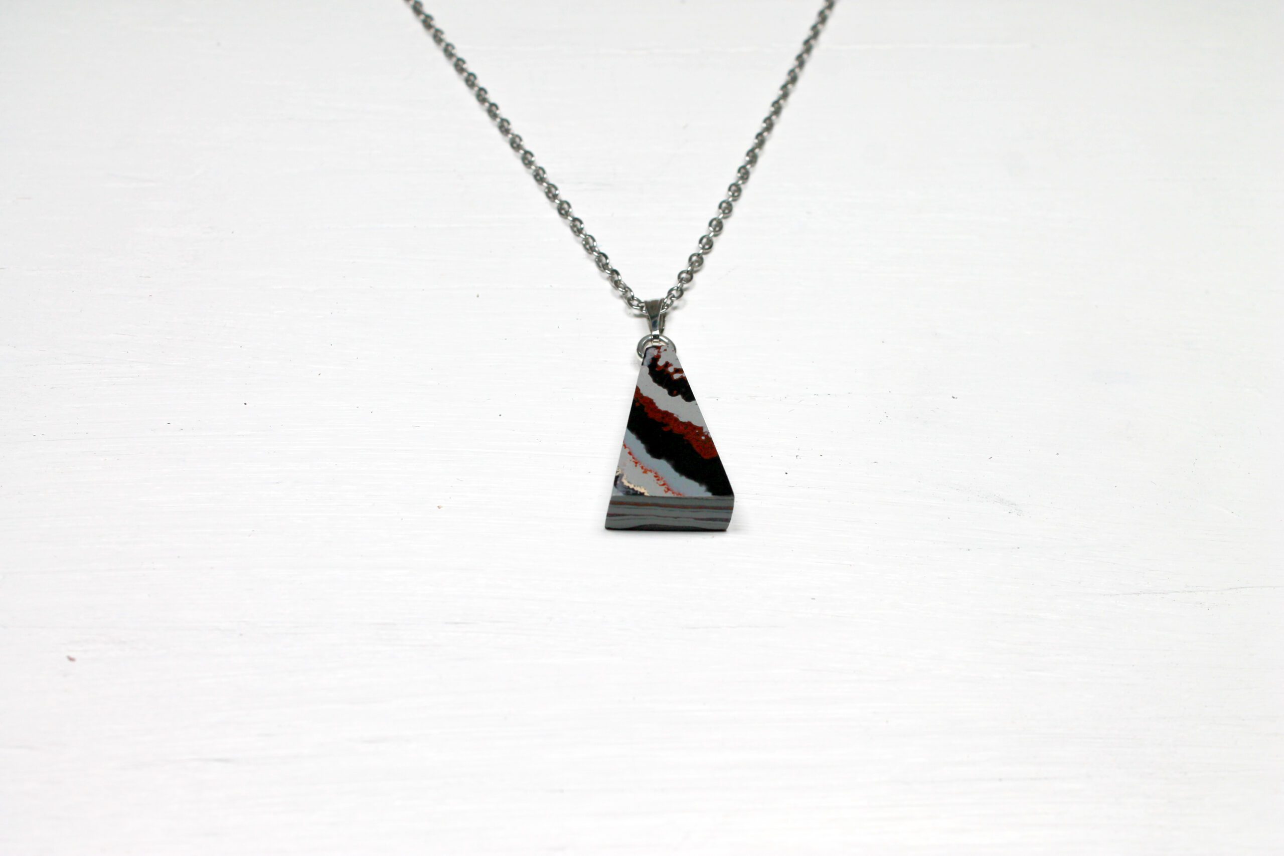 Triangular pendant necklace on simple chain.