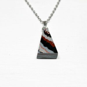 Triangular stone pendant on silver chain.