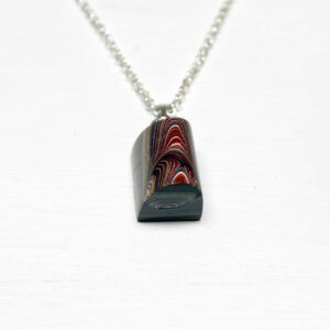Colorful pendant with chain on white background.