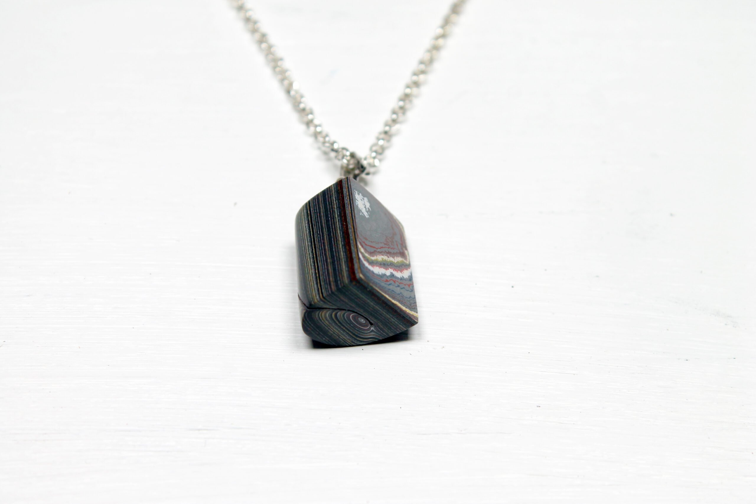 Layered stone pendant on silver chain.