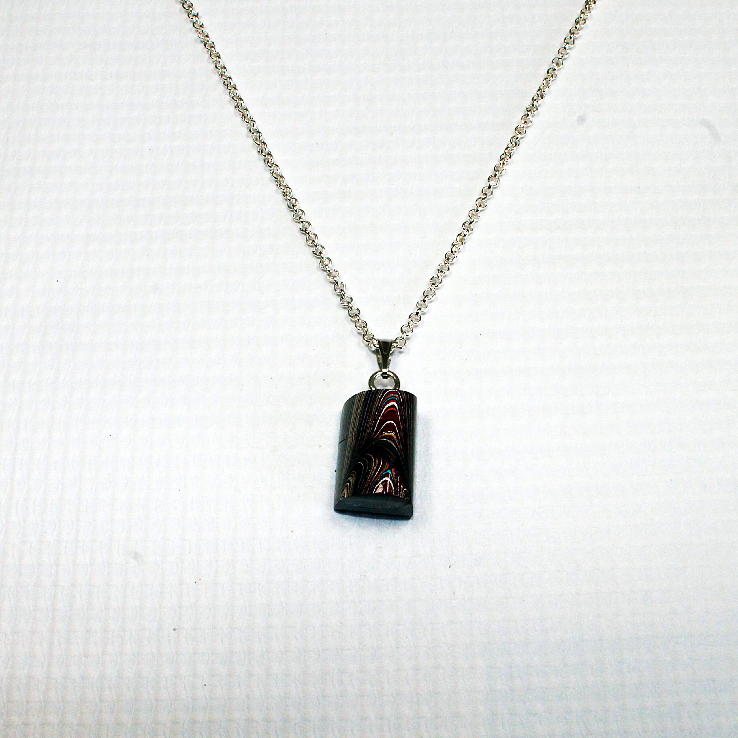Necklace with rectangular pendant on chain.