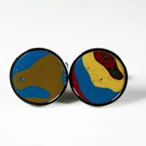 Colorful round cufflinks on white background.