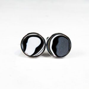 Black and white round cufflinks on display.