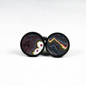 Colorful abstract pattern cufflinks on white background.